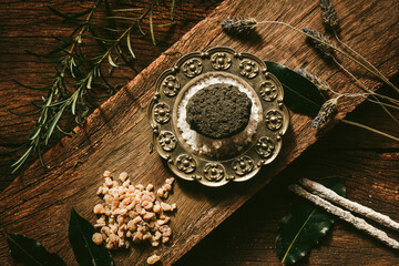 Wall Mural - Charcoal burning with incense, incense resin, rosemary, laurel, lavender on a rustic wooden table, 
smudge stick, smudging, energetic cleansing and smoking.Sahumar
