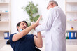 © Elnur - Young male patient visiting old male doctor in vaccination conce