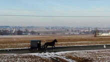 AERIAL Horse And Buggy Driving Along Snowy Country Road