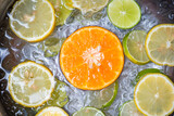 Fototapeta Młodzieżowe - Summer drinks refreshing of cold drinks fresh fruit on ice bucket homemade cocktail tea with mojito lemon lime orange slice, summer drink juicy