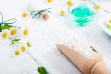 Canvas Print - beauty product samples with chamomile flowers on white wooden table