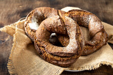 Rye Flour Bagels In A Basket On A Brown Wooden Background. Delicious And Healthy Homemade Bread Closeup