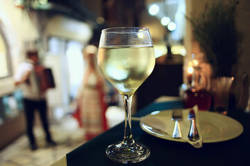 Wall Mural - evening in a restaurant, blurred abstract background, bokeh, alcohol concept, wine glasses in a bar