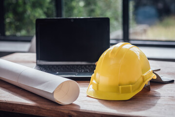 Yellow hard safety helmet hat for safety project of workman as engineer on together joining concept at construction site background.