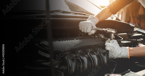 Automobile mechanic repairman hands repairing a car engine automotive workshop with a wrench, car service and maintenance,Repair service.