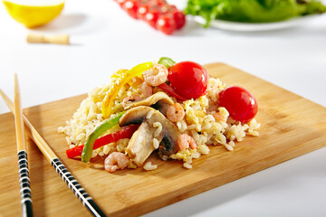 Canvas Print - Chicken Fried Rice with Vegetables. Asian style food on white background. Wooden dish with chopsticks.