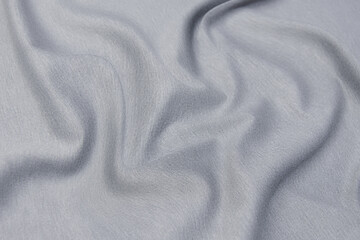 Close-up texture of natural gray fabric or cloth in gray color. Fabric texture of natural cotton or linen textile material. Gray canvas background