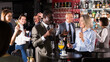 © JackF - Cheerful African businessman having fun with mature female coworker during office party at nightclub