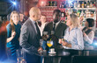 © JackF - Group of smiling men and woman drinking alcohol and having conversation on corporate party