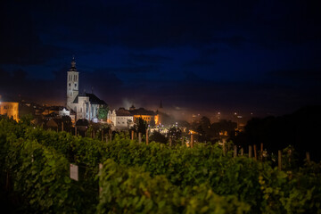 Landscape or cityscape Picture of Kutna hora town with Saint James church, full of historic buildings from ancient age in gothic style during sunset in spring, world heritage of Unesco. Czech Republic