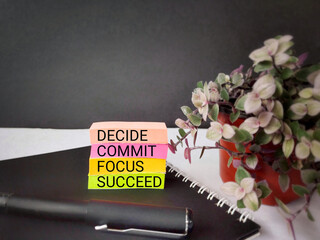 Wall Mural - Inspirational and Motivational Concept - DECIDE COMMIT FOCUS SUCCEED text on colourful paper background. Stock photo.