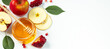 Happy Rosh Hashanah. Traditional Jewish holiday New Year. Apples, pomegranates and honey on white background. Banner format, place for text.