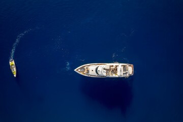 Wall Mural - aerial top down view of a luxury yacht over blue ocean