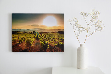 Wall Mural - Canvas photo print and flowers in vase, interior decor. Landscape photography hanging on white wall