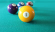 © Albina - Balls from a pool or billiard on a billiard table with a number 1 ball on green background.