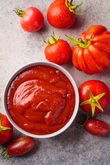 Canvas Print - Homemade tomato sauce in gray bowl. Cooking from summer vegetables concept.