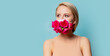 Beautiful blonde woman in facemask with roses