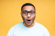 © denis_vermenko - Surprised amazed african american indian man guy in casual isolated over yellow background studio portrait. People lifestyle concept. Mock up copy space. Keeping mouth open.