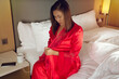 Women wore on red sexy nightgown & long sleeve satin robe with floral lace in the bedroom at night