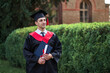 © Тарас Нагирняк - Portrait of handsome caucasian male graduate in graduation robe looking at campus