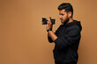 © Тарас Нагирняк - Young hindu photographer in black hoody with camera on background with copy space