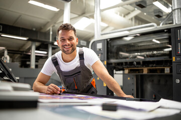 Wall Mural - Portrait of worker at control room checking print quality at printing house.