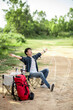 © Johnstocker - Young man relax with coffee at nature park during camping