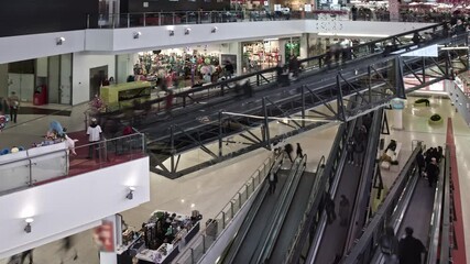 Wall Mural - The movement of people on escalators in the modern mall , time lapse