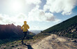 © lzf - Woman ultramarathon runner running at mountain top