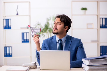 Young male employee in e-commerce concept