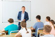 © JackF - Portrait of adult male teacher conducting lesson for teenage schoolchildren listening attentively to him