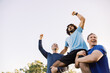 © Austockphoto - close up shot of two men carrying a man on their shoulders while raising their arms up high