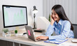 © Orathai - Asian woman working on a laptop with a cheerful and happy smile while working at the office