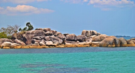 The beauty of Tanjung Tinggi beach on Belitung Island with giant granite rocks, clear water and white sandy beaches. Bangka Belitung, Indonesia