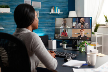 African american woman discussing with university team planning marketing course ideas during online webinar videocall conference meeting. Black computer user working remote from home