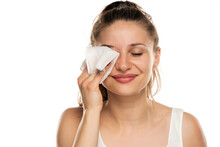 A Smiling Woman Cleans Makeup From Her Face With Wet Wipe