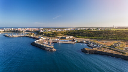 Canvas Print - Aerial. The maritime dock in the Portuguese city of Sines and the sailboat is moored for tourist excursions. Blue ocean. Sanny day