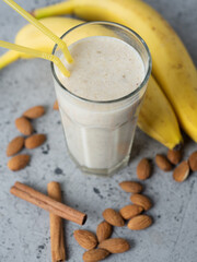 Wall Mural - Milk smoothie cocktail for breakfast with banana, almonds and cinnamon