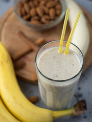 Wall Mural - Milk smoothie cocktail for breakfast with banana, almonds and cinnamon