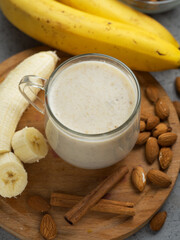 Wall Mural - Milk smoothie cocktail for breakfast with banana, almonds and cinnamon