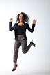 © NVB Stocker - beautiful young hispanic woman jumping and smiling afro hairstyle isolated on white background