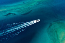 Large Speed Boat Moving At High Speed. Top View Of A White Boat Sailing To The Blue Sea. Drone View Of A Boat Sailing. Motor Boat In The Sea.