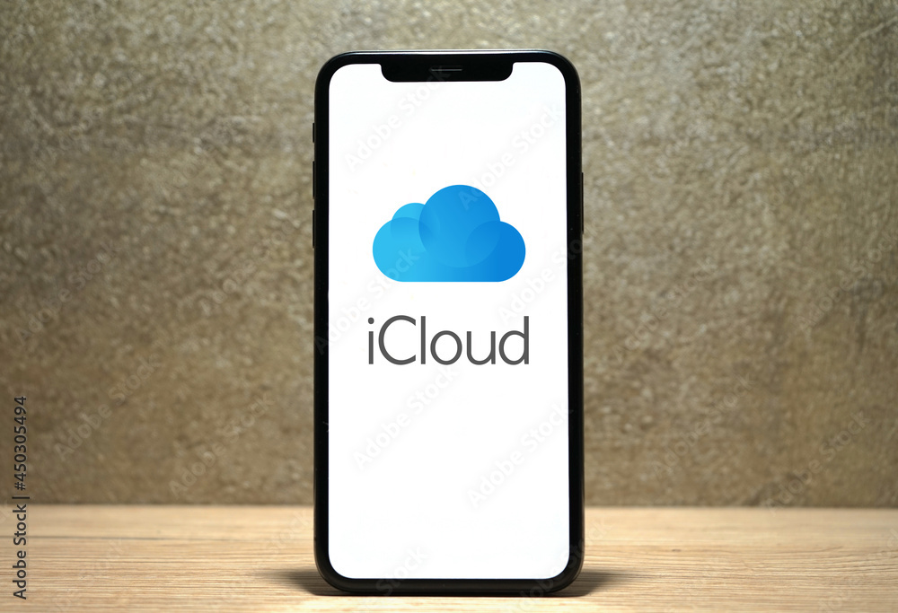iCloud logo is displayed on a smartphone, with the Apple logo in the ...