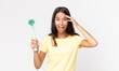 © kues1 - young hispanic woman looking happy, astonished and surprised and holding a dish cleaning brush