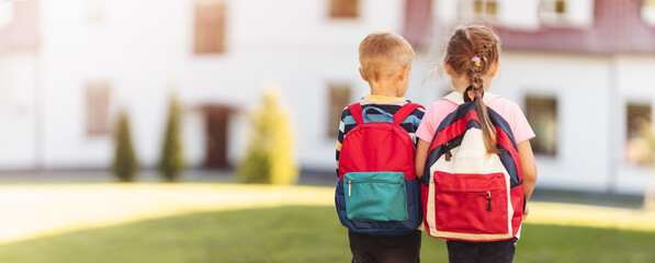 Wall Mural - Children with backpacks going to the school