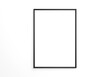 © CreatifyStudio - black vertical frame mockup on white wall. 3d rendering.