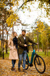 © BGStock72 - Young couple in the autumn park with electrical bicycle