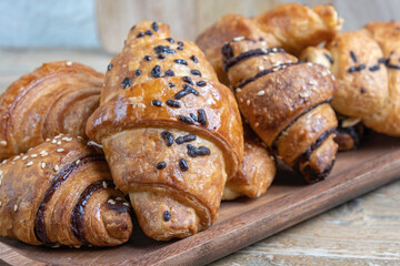 Wall Mural - Chocolate croissant on wooden background.