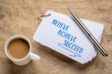 Wall Mural - believe, achieve, succeed motivational words - handwriting on a stuck of index card with a cup of coffee, business, goal setting and personal development concept