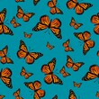 Seamless monarch butterflies on teal background pattern